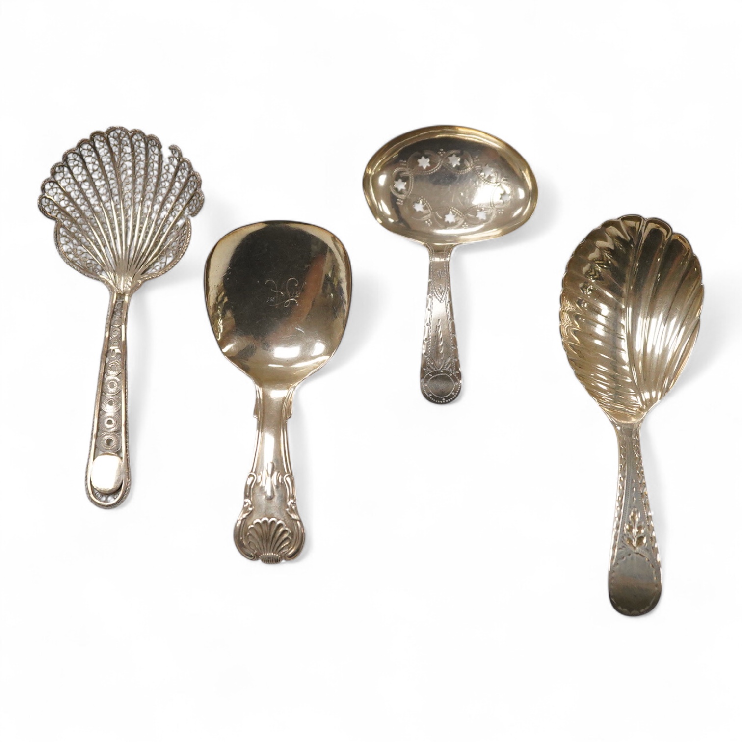 Three assorted silver caddy spoons, including star cut bowl by John Thropp, Birmingham, 1817, 69mm, hourglass? pattern, Joseph Wilmore, marks rubbed, bright cut engraved handle London, 1856 and a filigree white metal spo
